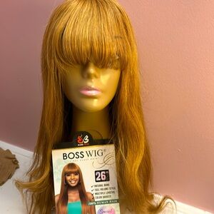 Honey, blonde, soft silky human hair wig with bangs.
